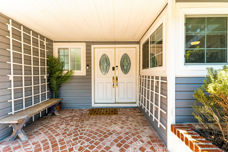 A stunning herringbone brick porch with a soldier course border - porch brick design