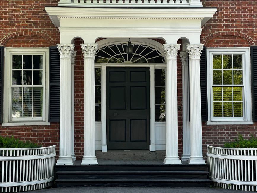 colonial-style home with a matching brick walkway