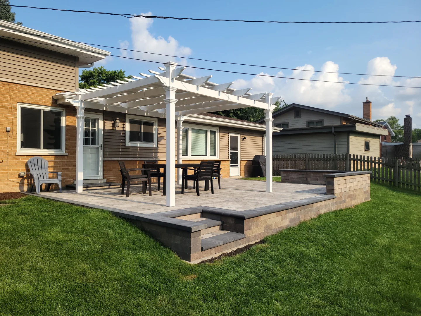 terraced paver patio with retaining wall seating and steps