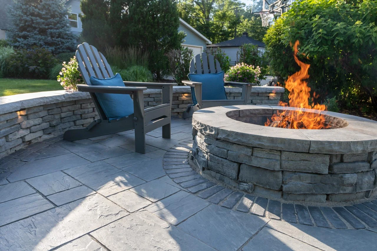 family relaxing on herringbone red brick patio around fire pit golden hour family relaxing on herringbone red brick patio around fire pit golden hour