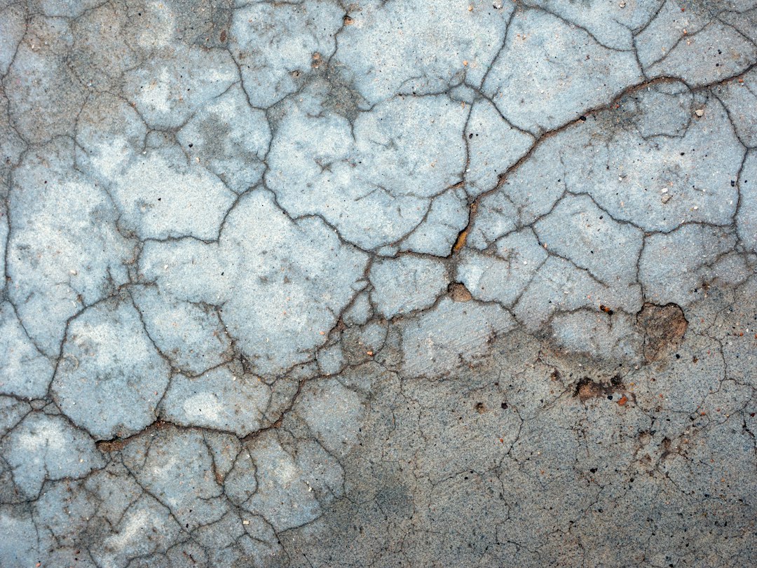 cracked concrete and shifting pavers