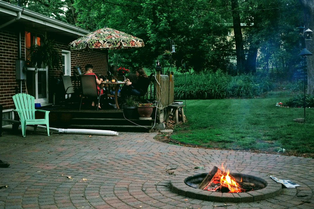 custom brick paver patio with built-in fire feature