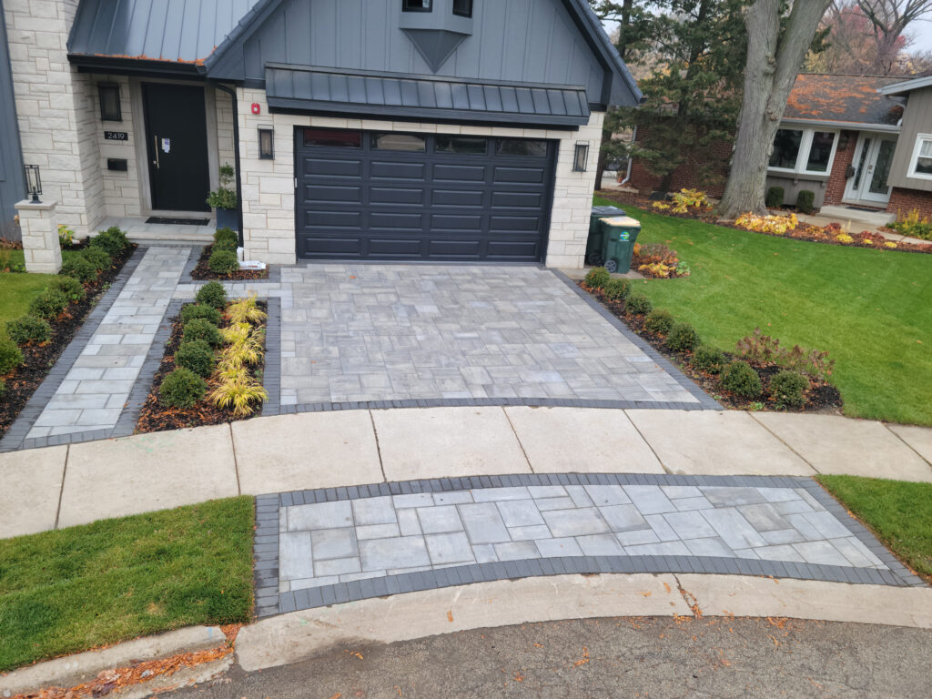 Modern luxury house with a professionally installed stone paver driveway.