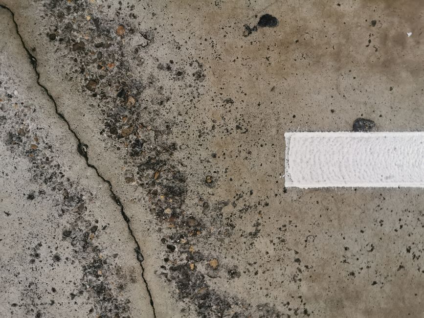 cleaning driveway cracks with a wire brush to remove dirt and weeds cleaning driveway cracks with a wire brush to remove dirt and weeds