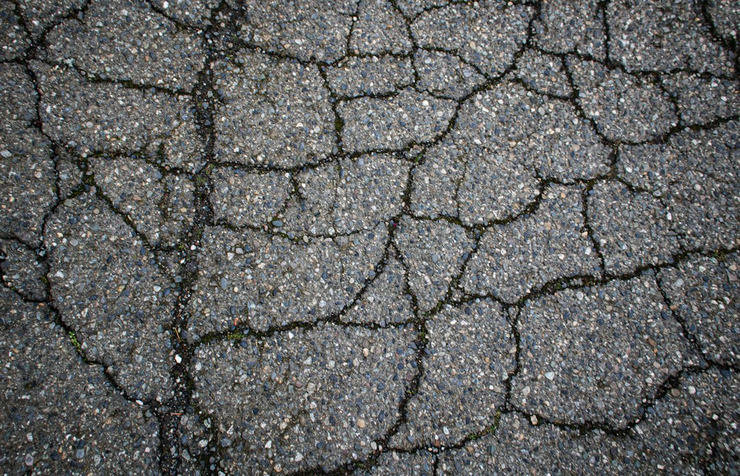 crumbling asphalt driveway edge showing structural failure crumbling asphalt driveway edge showing structural failure