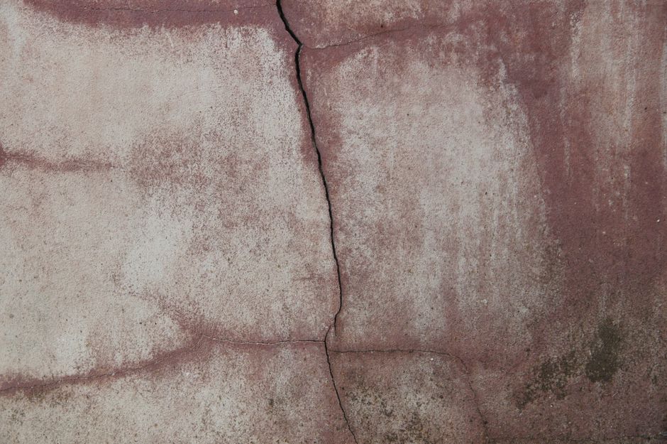 Homeowner preparing a concrete crack with a chisel in Chicago suburb
